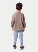 Model wearing the Kids Cashmere Track Pants in light gray, full-length back view