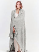 Model wearing the Cable Knit Cashmere Blanket in Dawn Blue, full-length front view