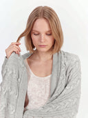 Model wearing the Cable Knit Cashmere Blanket in Dawn Blue, close front view
