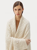 Model wrapped in the Cable Knit Cashmere Blanket in Off-White, close front view