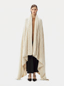 Model wrapped in the Cable Knit Cashmere Blanket in Off-White, full-length front view