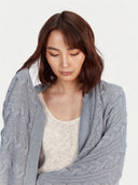 Model wearing the Cable Knit Cashmere Blanket in high rise, close front view