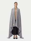 Model wrapped in the Cable Knit Cashmere Blanket in High Rise, front view