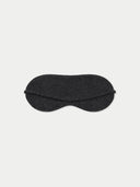 Flat lay of the charcoal cashmere fine-knit eye mask with its slim strap, against a light gray background.