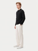 Model wearing the Cashmere Classic Polo Sweater in Black, three-quarter side view