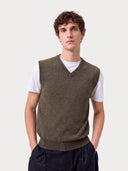 Man wearing the olive green Timeless V-Neck Cashmere Vest over a white T-shirt, front view