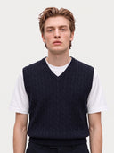 Model wearing the Cashmere Cable-Knit V-Neck Vest in Navy over a white T-shirt, close front view