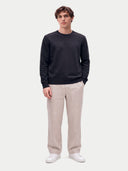 Model wearing the Cashmere Fine Crewneck Sweater in Navy, full-length front view