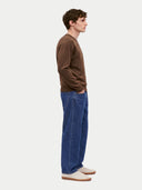 Model wearing the Cashmere Fine Crewneck Sweater in Dark Brown, three-quarter side view