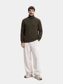 Timeless Cashmere Turtleneck Sweater in avocado, worn by a model