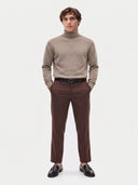 Model wearing the Cashmere Turtleneck Sweater in Taupe, full-length front view