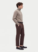 Model wearing the Cashmere Turtleneck Sweater in Taupe, three-quarter side view