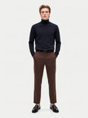 Model wearing the Cashmere Turtleneck Sweater in Navy, full-length front view