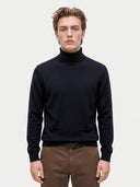 Model wearing the Cashmere Turtleneck Sweater in Navy, front view