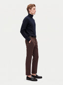 Model wearing the Cashmere Turtleneck Sweater in Navy, three-quarter side view