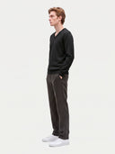Model wearing the Cashmere V-Neck Sweater in Black, three-quarter side view