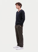 Model wearing the Cashmere V-Neck Sweater in Navy, three-quarter side view