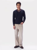 Model wearing the Cashmere Cricket V-Neck Sweater in Navy with light beige jeans, full-length front view