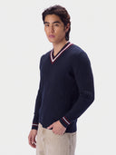Model wearing the Cashmere Cricket V-Neck Sweater in Navy, three-quarter front view with the striped V-neck and cuffs