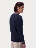 Model wearing the Cashmere Cricket V-Neck Sweater in Navy, back view