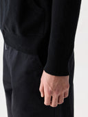 Men's Zip-Up Cashmere Hoodie Black worn by model, detail view on white background