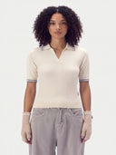 Close front view on model of the Pure White rib-knit polo sweater with grey-striped collar and cuffs