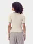 Back view on model of the Pure White rib-knit polo sweater with grey collar and cuff stripes