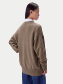 Model wearing the Cashmere Loose-Fit V-Neck Cardigan in Taupe, back view