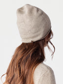 Model wearing the Cashmere Hat & Sweater Set in Natural Beige, back view