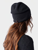 Model wearing the Cashmere Hat & Sweater Set in Navy, back view