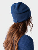 Model wearing the Cashmere Hat & Sweater Set in Deep Blue, back view