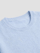 Close-up of the ribbed crew neckline of the Seamless Cashmere Clean Crewneck Sweater in Soft Blue