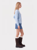 Model wearing the Seamless Cashmere Clean Crewneck Sweater in Soft Blue, side view
