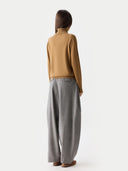 Women's Classic Cashmere Turtleneck Sweater Almond worn by model, back view, on white background