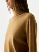 Women's Classic Cashmere Turtleneck Sweater Almond worn by model, side view, on white background