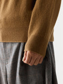 Women's Classic Cashmere Turtleneck Sweater Almond worn by model, detail view, on white background