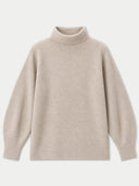 A light beige knit turtleneck sweater with a soft, fine texture, displayed flat against a light gray background.