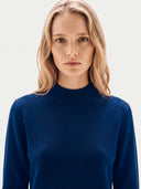 Model wearing the Seamless Cashmere Mock Neck Sweater in Deep Blue, close front view