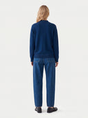 Model wearing the Seamless Cashmere Mock Neck Sweater in Deep Blue, back view