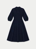 A dark navy blue long-sleeve polo dress with a flared skirt, shown against a light gray background.