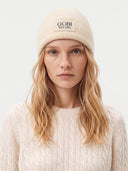 Model wearing the Cashmere Rib-Knit Beanie in off white, front view