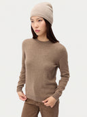 Model wearing the Seamless Cashmere Cuffless Beanie in Natural Beige, full-length front view