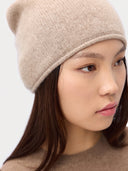 Model wearing the Seamless Cashmere Cuffless Beanie in Natural Beige, close front view