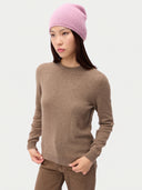 Model wearing the Seamless Cashmere Cuffless Beanie in Light Pink, full-length front view