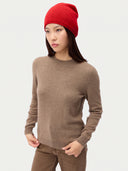Model wearing the Seamless Cashmere Cuffless Beanie in Bright Red, full-length front view