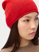 Model wearing the Seamless Cashmere Cuffless Beanie in Bright Red, close front view
