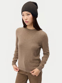 Model wearing the Seamless Cashmere Cuffless Beanie in Olive Brown, full-length front view