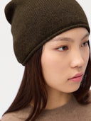 Model wearing the Seamless Cashmere Cuffless Beanie in Olive Brown, close front view