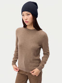 Model wearing the Seamless Cashmere Cuffless Beanie in Navy, full-length front view
