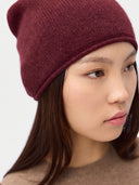 Model wearing the Seamless Cashmere Cuffless Beanie in Wine Red, close front view